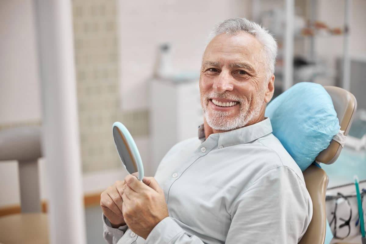 satisfied-senior-patient-in-dentist-office